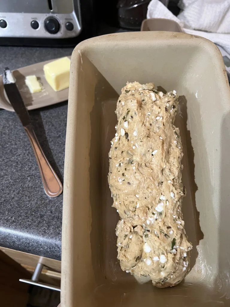 dilly onion bread dough rising in bread pan