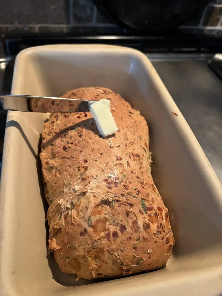 baked dilly onion bread recipe being buttered