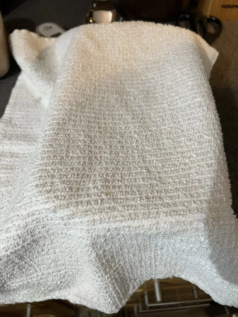 dill bread recipe under kitchen towel rising